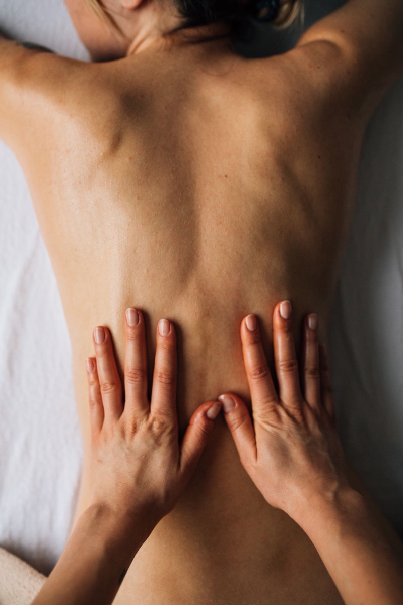Massage therapist working on a patient's back